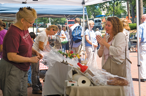 Vendor selling wares at Emory Farmers' Market