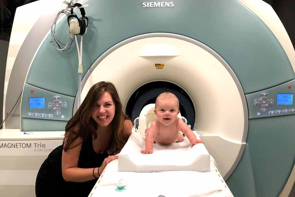 baby in mri machine with mother standing