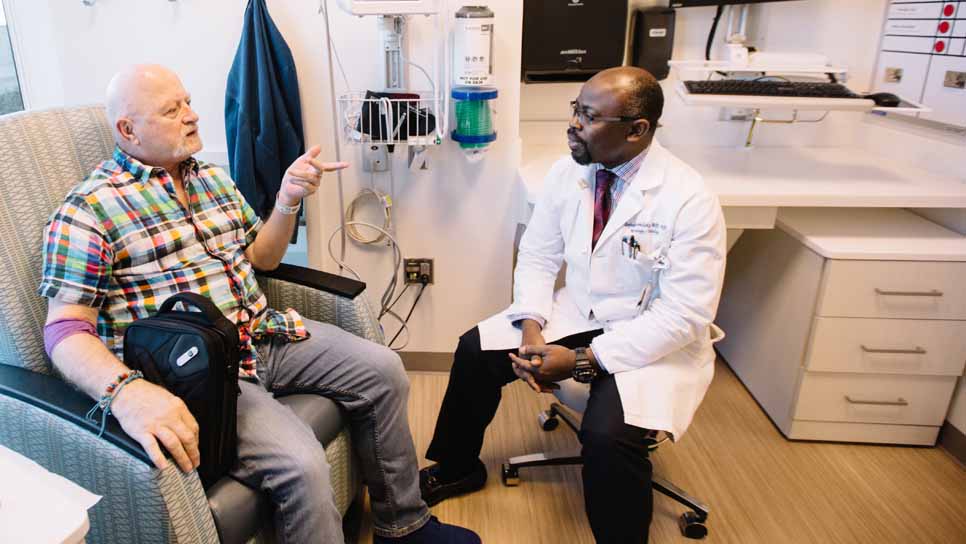 doctor talks with patient during his treatment