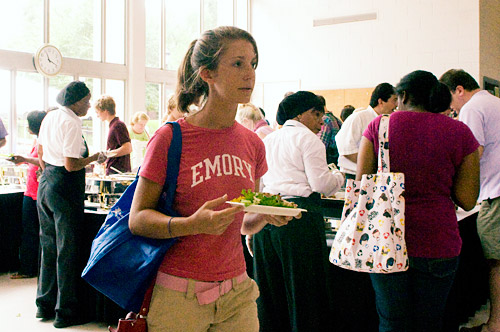 Student walking through cafeteria with a plate in her hands