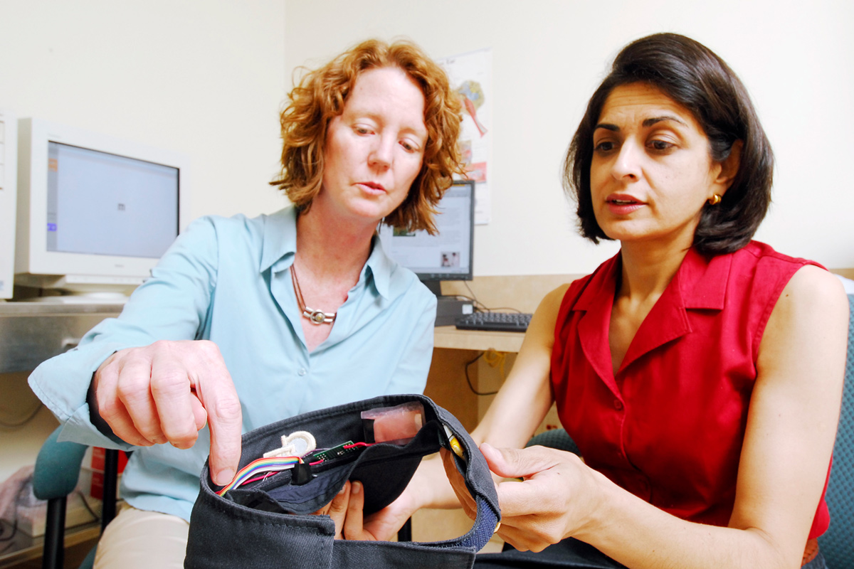  Pamela Bhatti and another researcher handling equipment