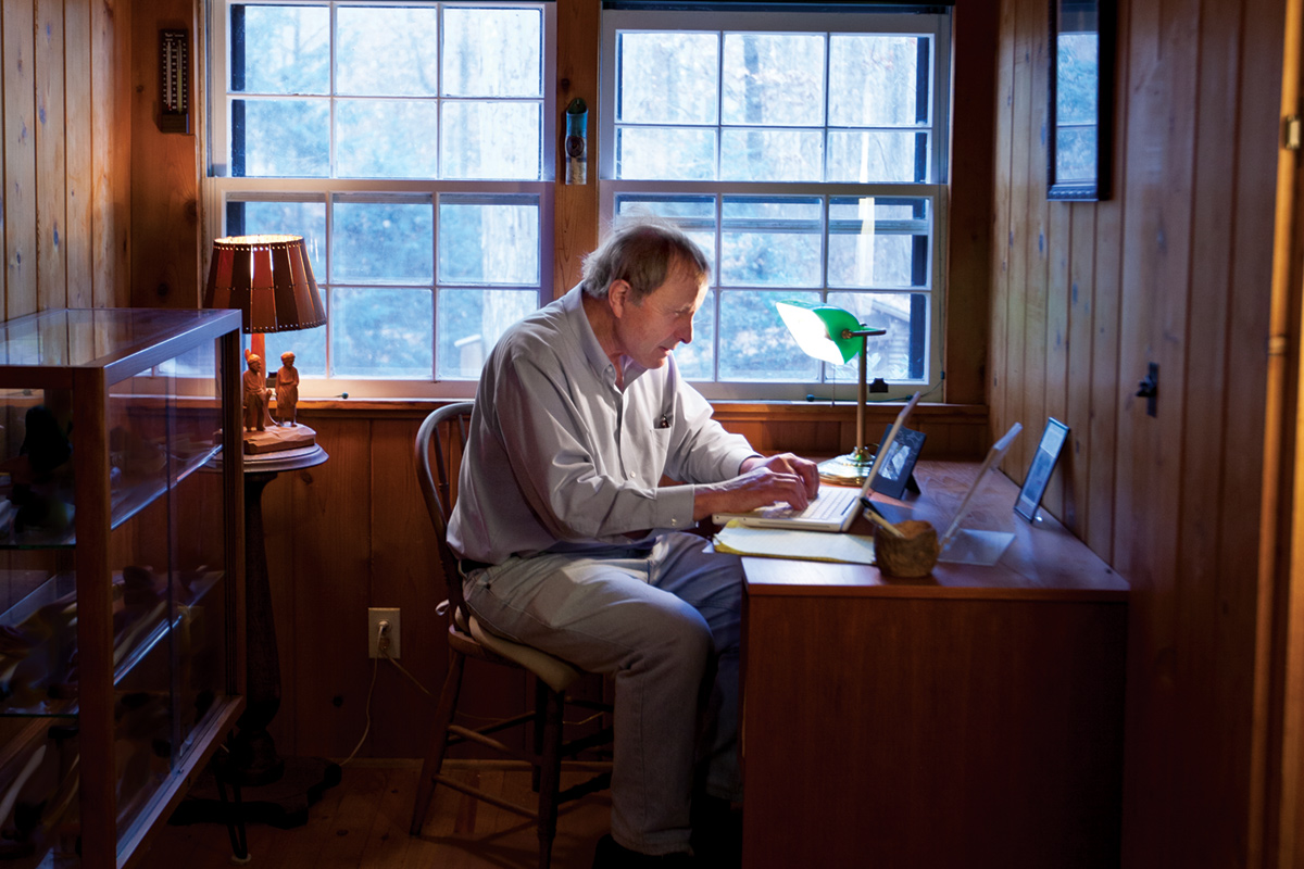 Writer Fred Menger at his desk in his writing studio