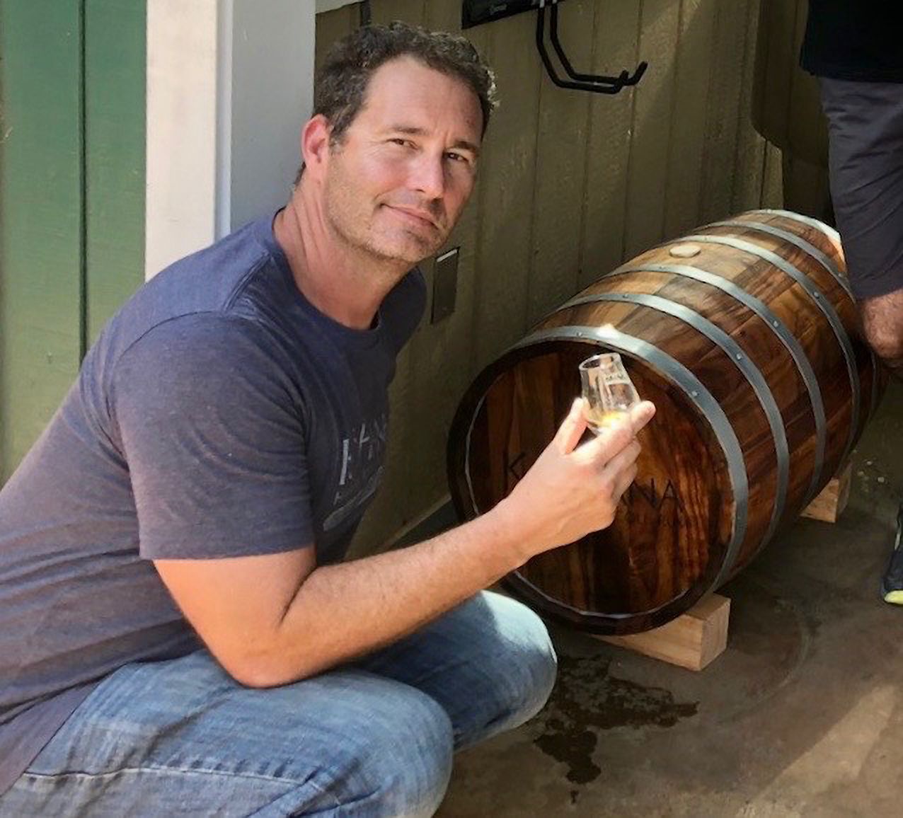 Photo of Dawson with a wooden barrel
