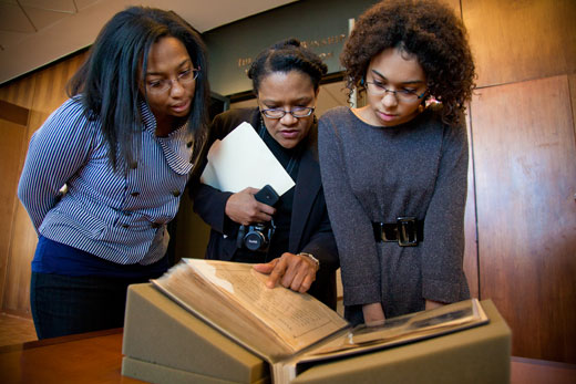 Rev. OJ Turner Family reviewing found scrapbook treasures in MARBL