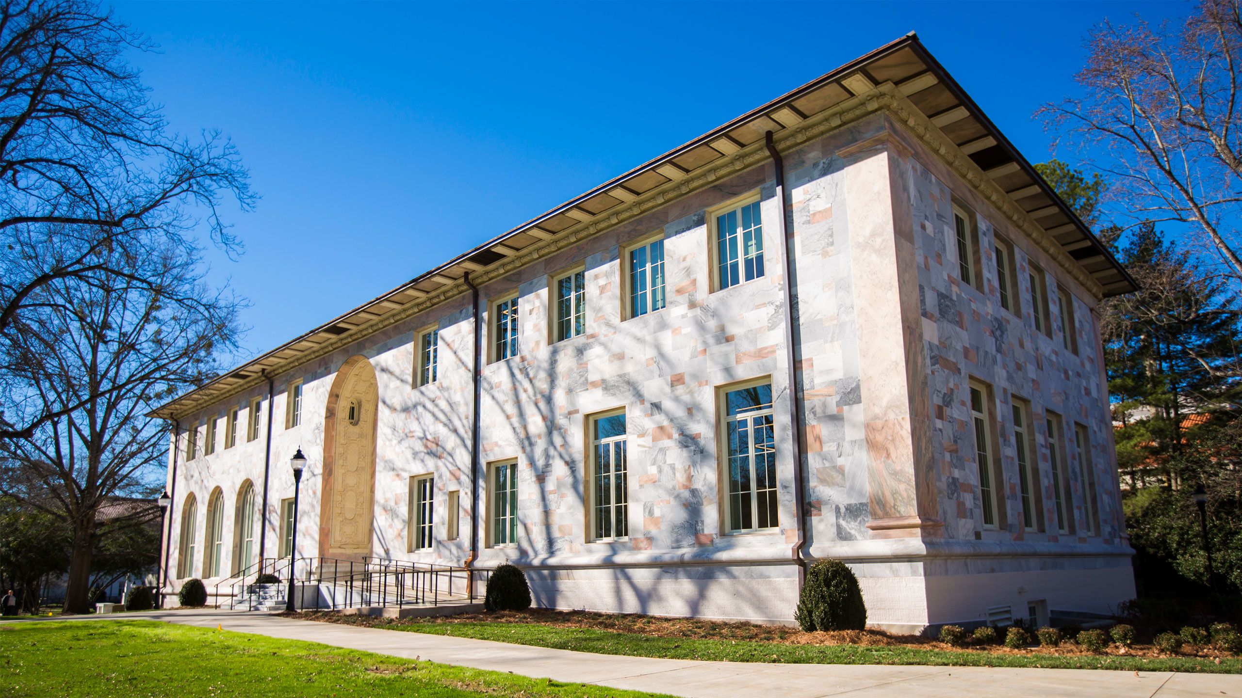 On a sunny, winter day, Convocation Hall is a building styled with the pink and gray marble that defines the university's main quadrangle