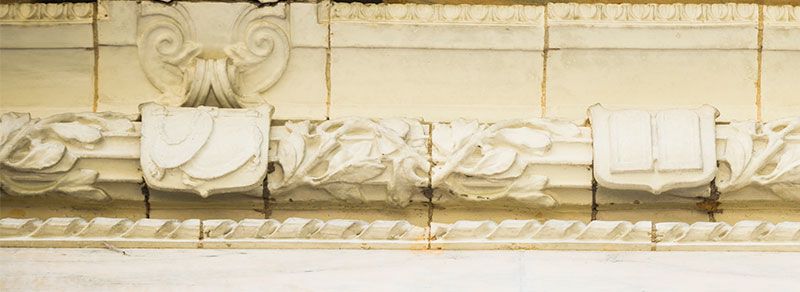 A close-up of scales and tablets carved into the marble