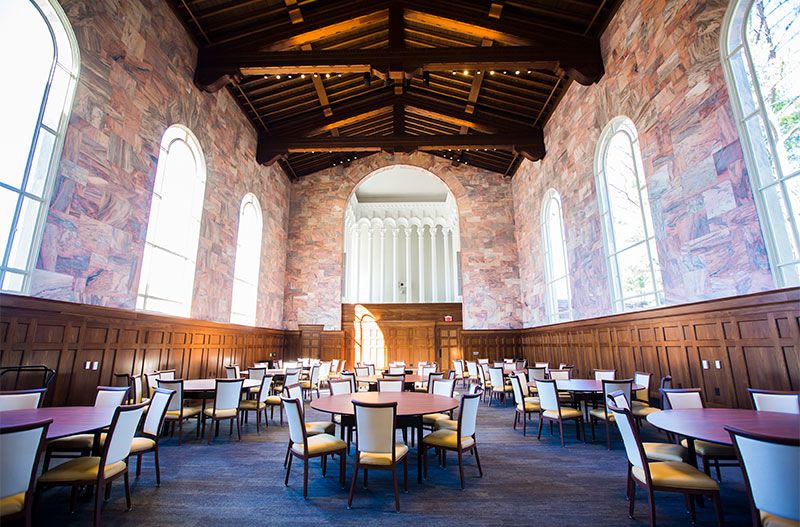 Circular tables and chairs are evenly spaced out in the newly-renovated chapel