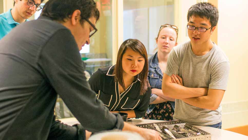 professor showing students some implements