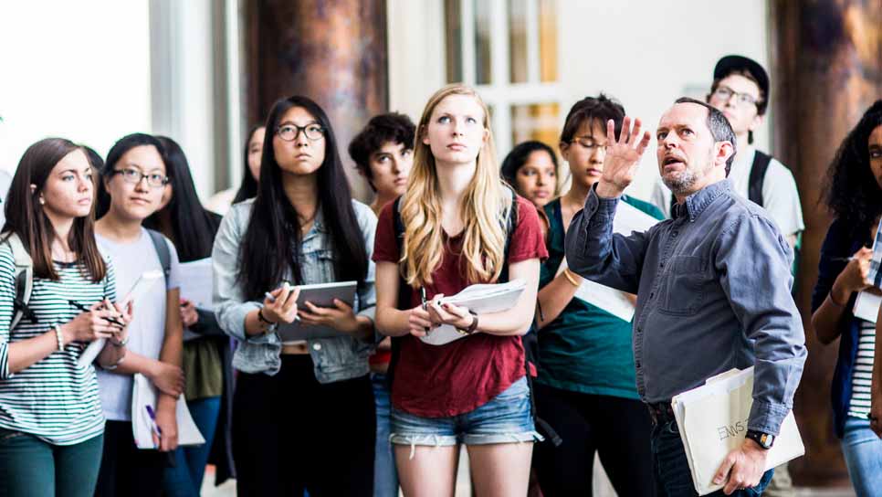 math/science professor teaching students outside the classroom