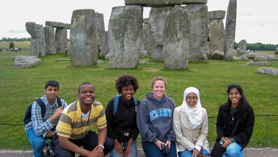 students sitting in front of Stonehedge 