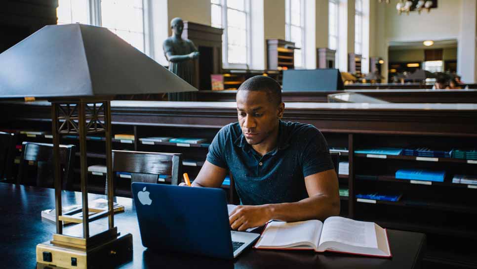 student studying in Matheson Reading room in Emory Library