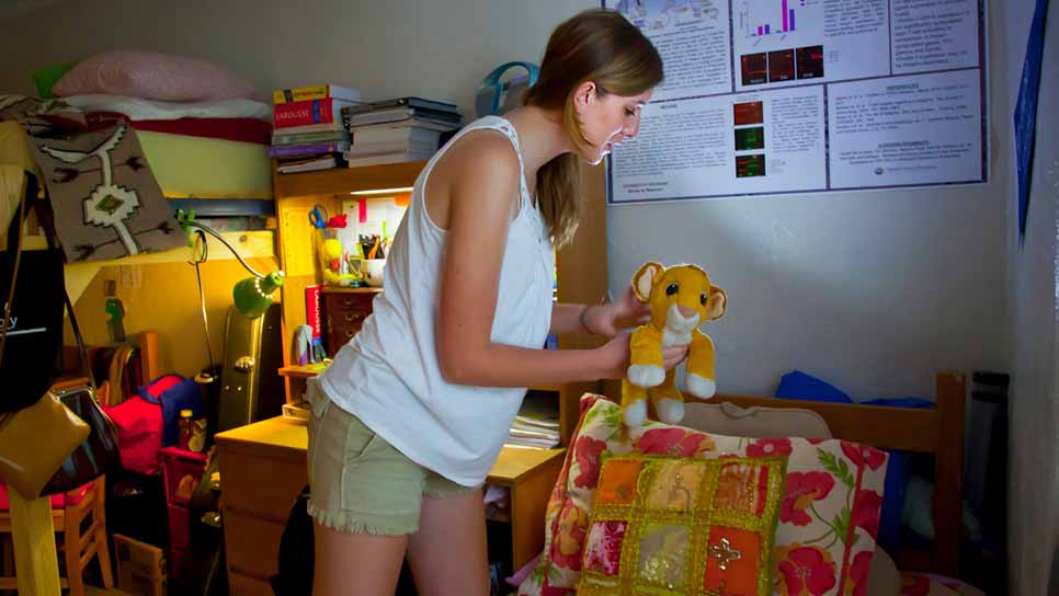 student organizing her dorm room