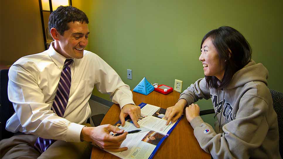 financial aid adviser helping student