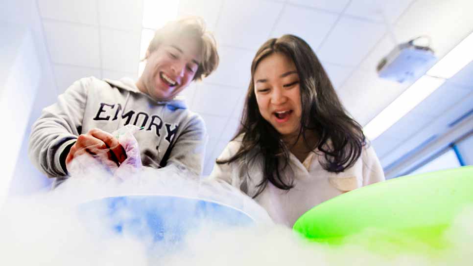 two students doing an experiment with smoke