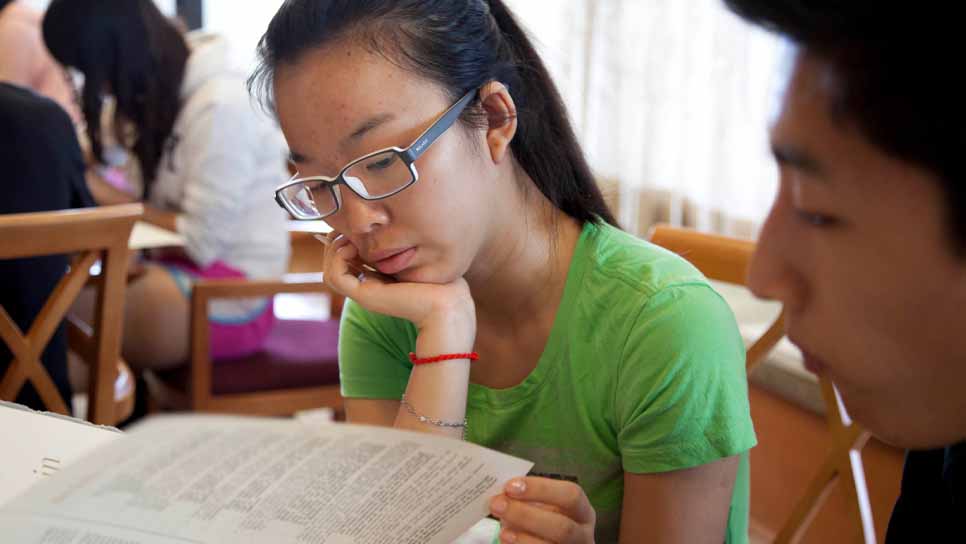 female student reading a book