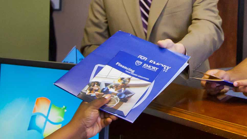 man handing book