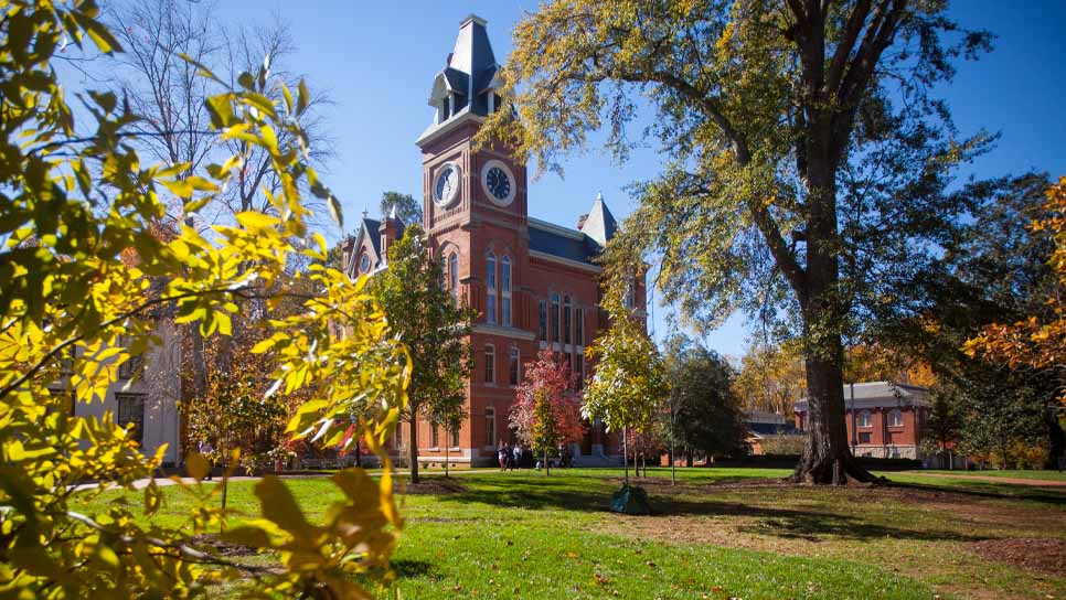 seney hall on a sunny day with blue sky and green grass