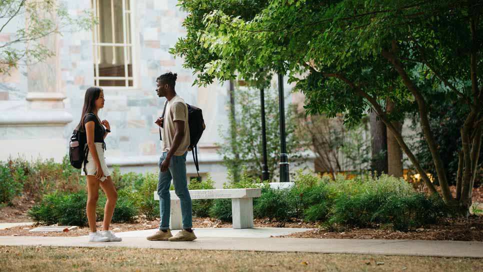 two students talking on the quad