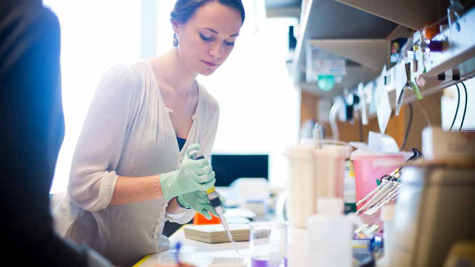 female student in lab with syringe