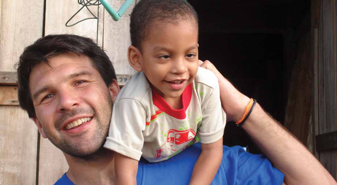 man holding up a young boy on his shoulder