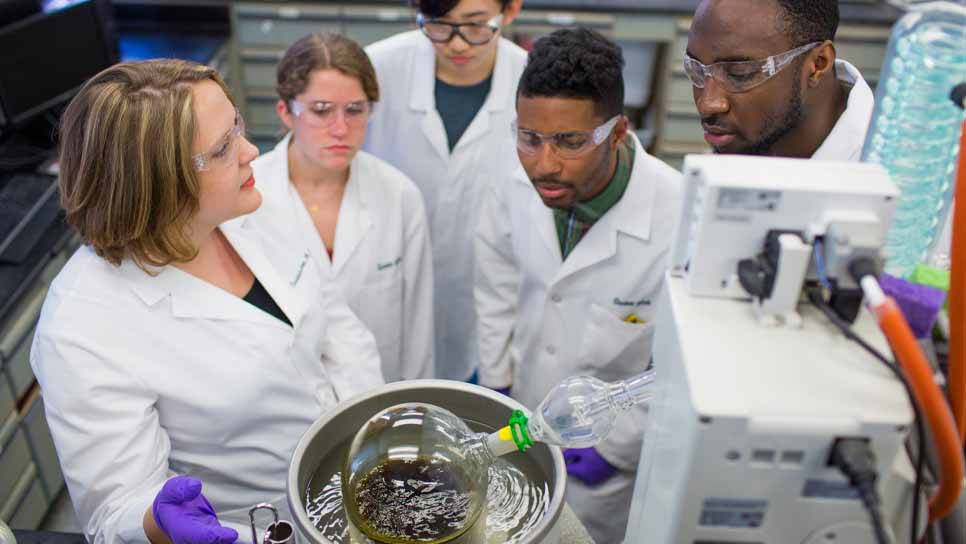 scientists in a lab performing an experiment