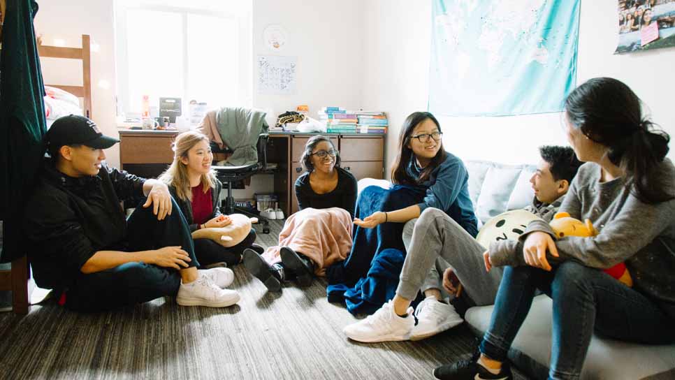 students talking in dorm room
