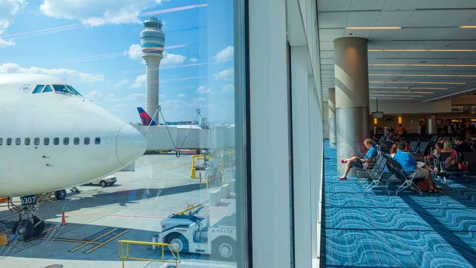 airplane parked outside gate waiting area