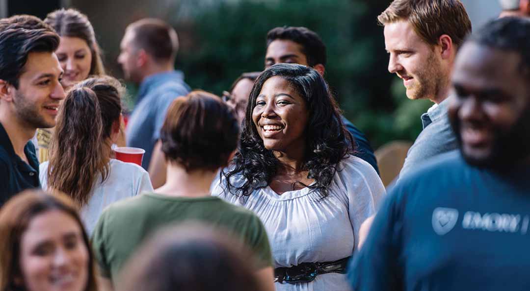 young woman talking and smiling in a group of people