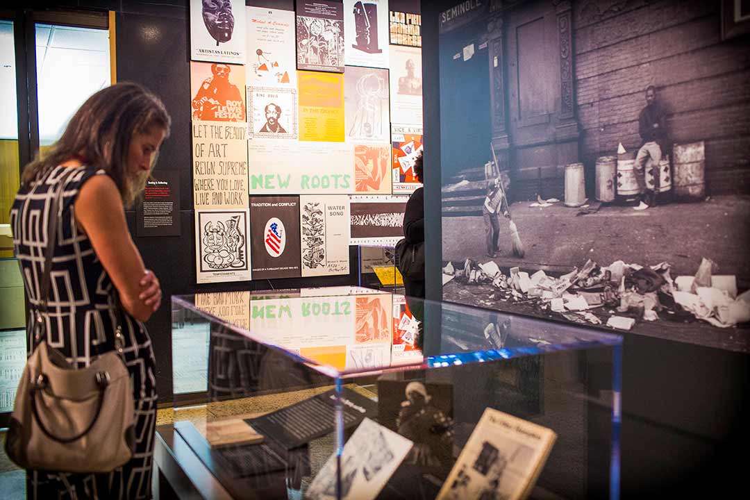 woman viewing an exhibit in the library