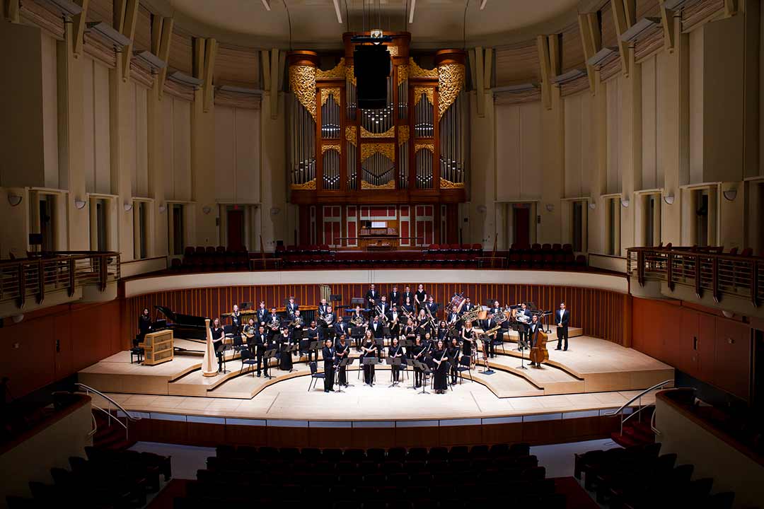 an orchestra on stage in the schwartz center