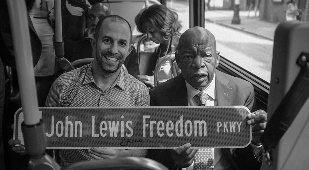 John Lewis and alumnus sitting together
