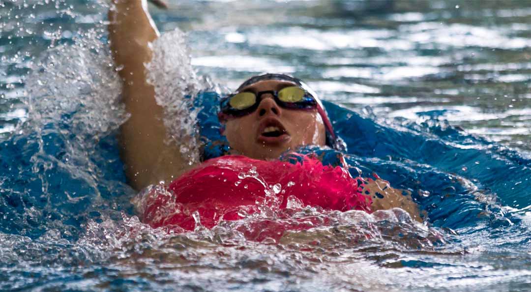woman swimming backstroke