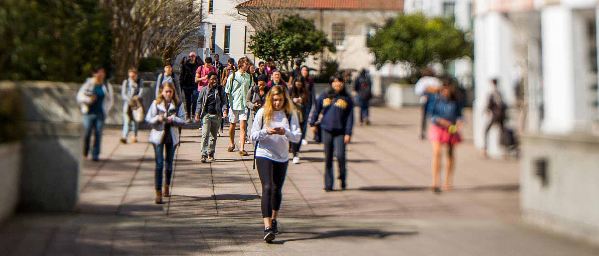 students walking on campus between classes