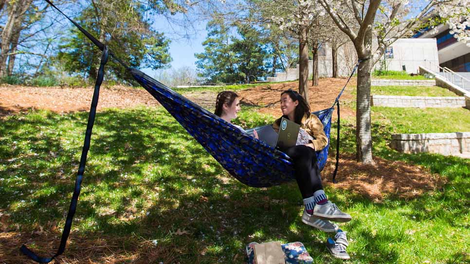 two students in hammock near quad