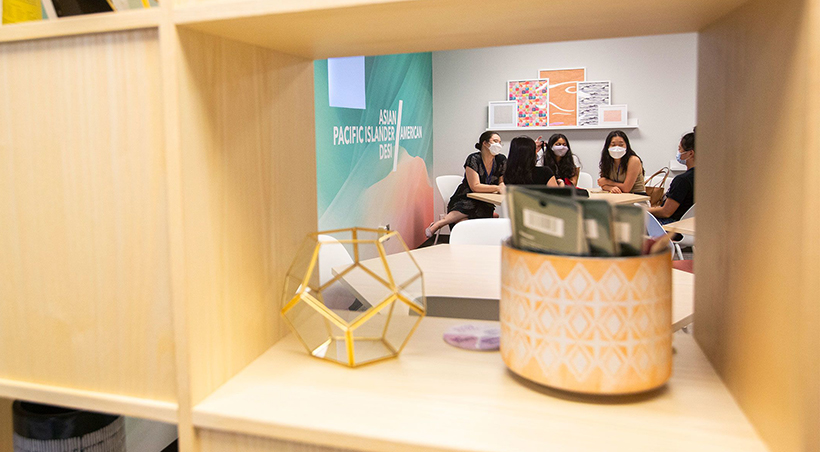 display on a shelf in foreground, students seated in background