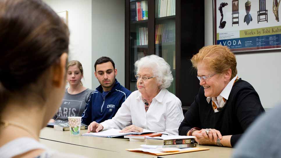 professor teaching class at table