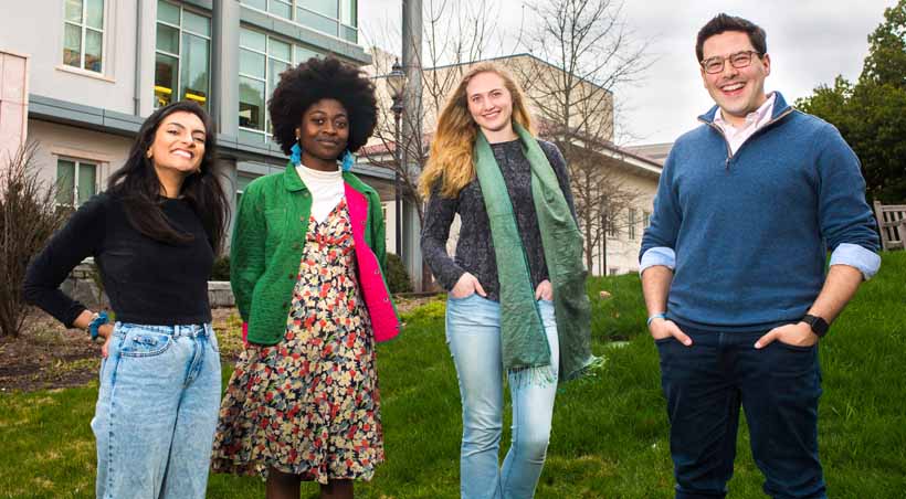 four students standing together