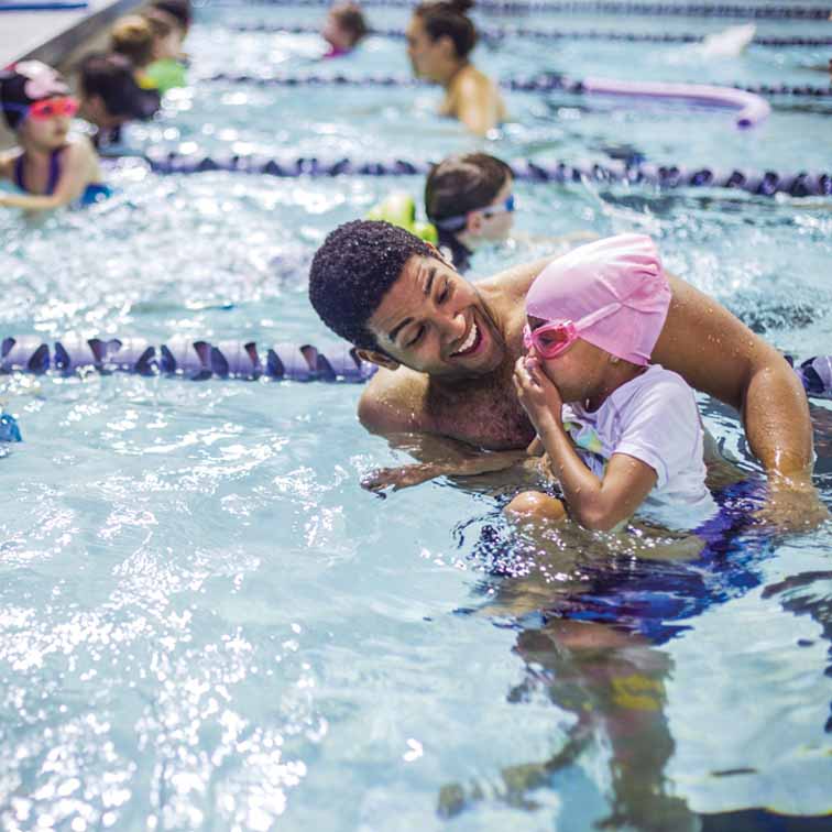 student teaching a child to swim