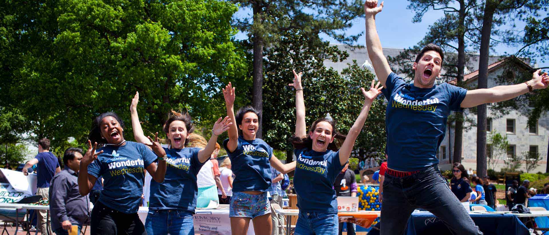 students jumping in air with wonderful wednesday tshirts on