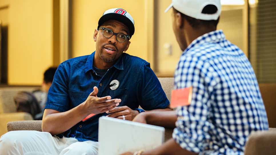 a professor and student sitting and talking