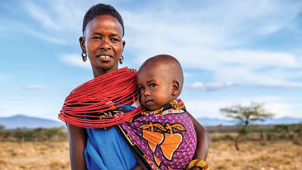 woman holds her baby outside