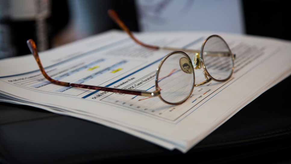 eyeglasses on top of a report