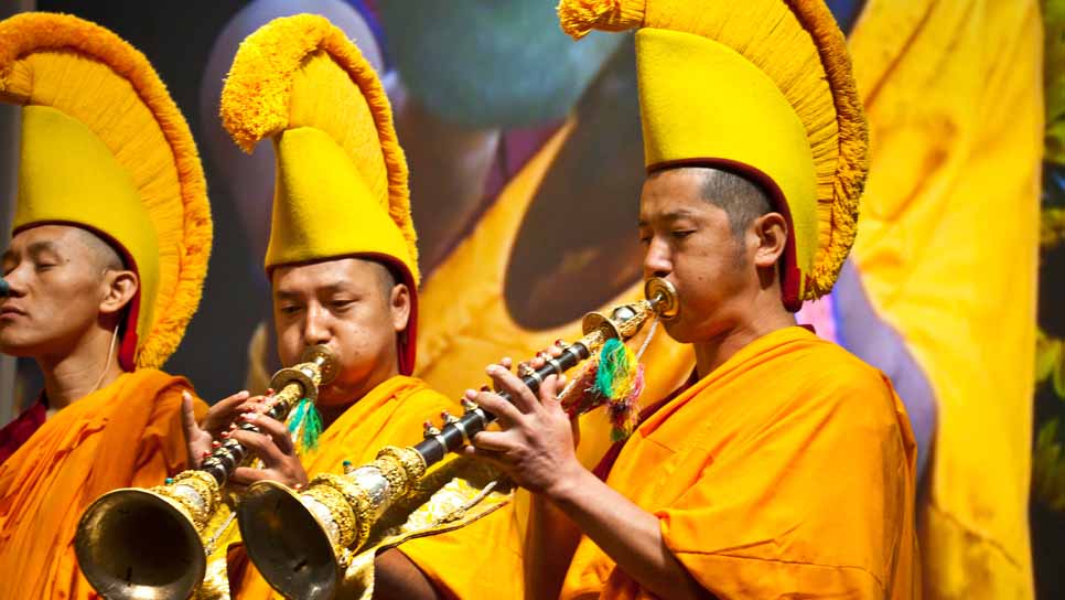 men in cultural clothing playing instruments