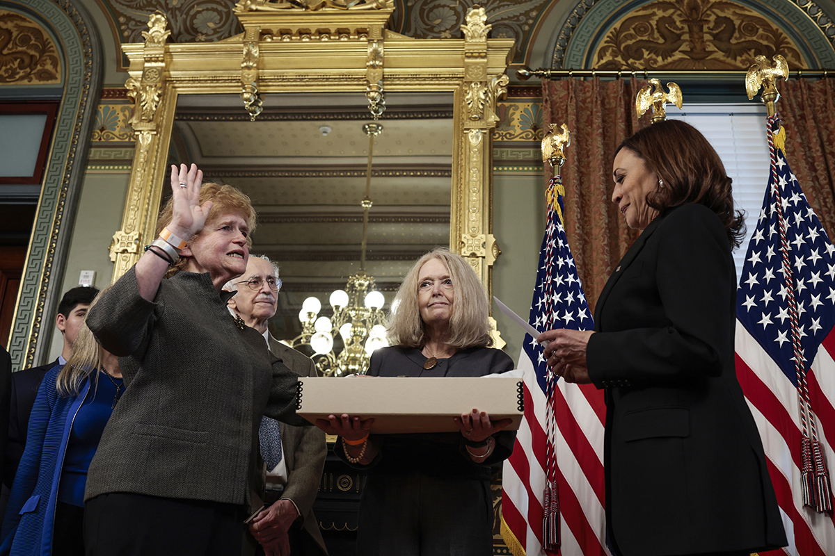 Deborah Lipstadt with her right hand raised being sworn in by Vice President Kamala Harris