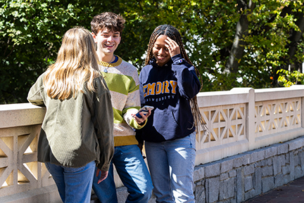 three students talk on the Emory campus