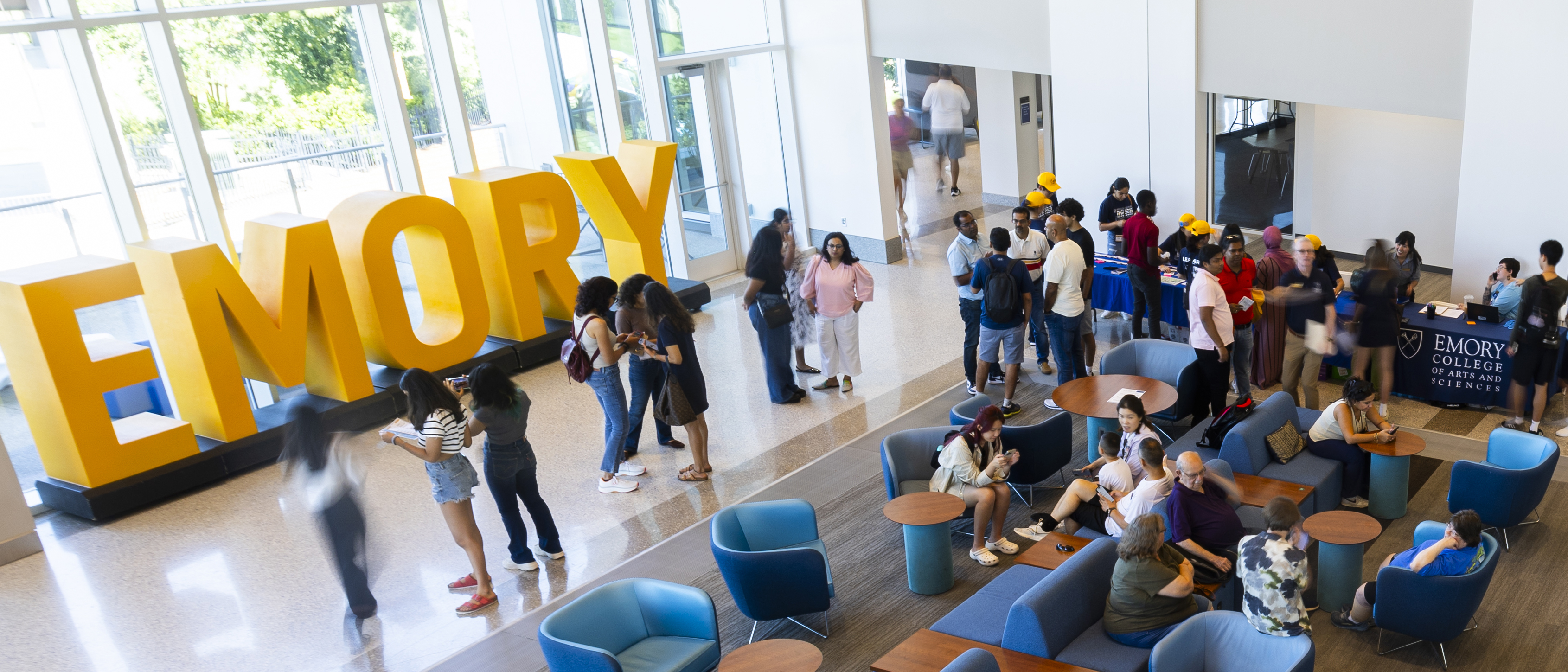 The Emory sign in the Student Center with students and their families