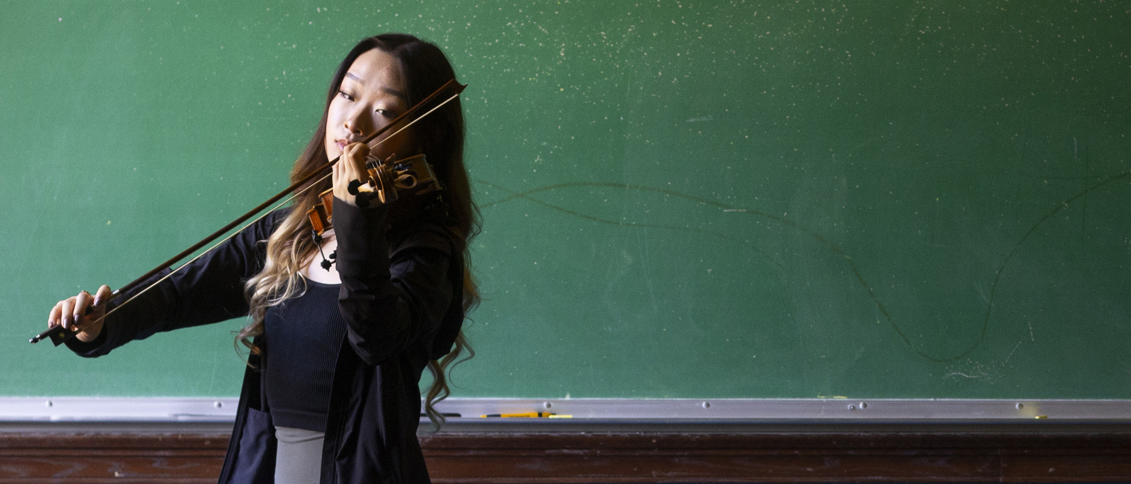 an Emory student playing the violin