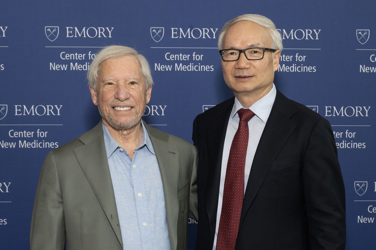 leaders pose in front of a banner that says Center for New Medicines