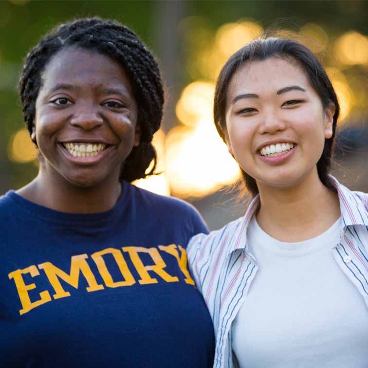 two female students standing together smiling