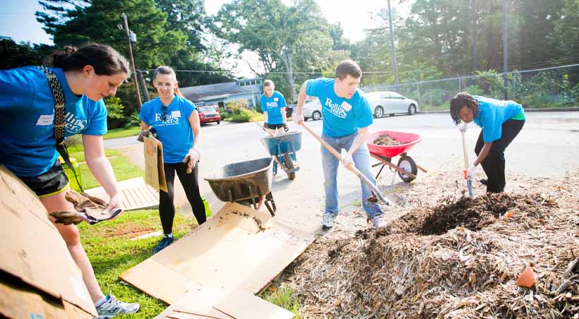 alumni volunteering with shovels